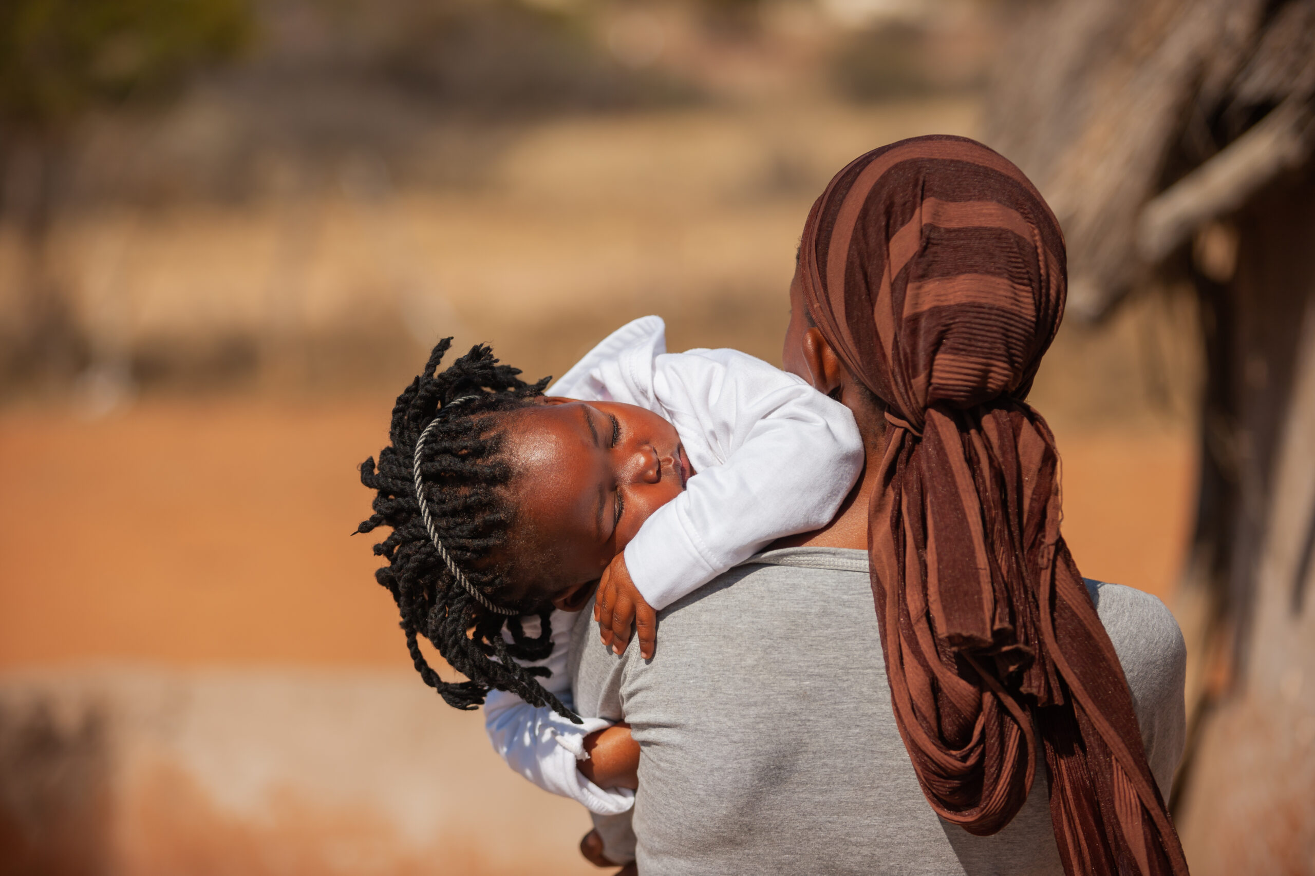 African,Woman,In,A,Village,In,Botswana,Carry,Her,Daughter